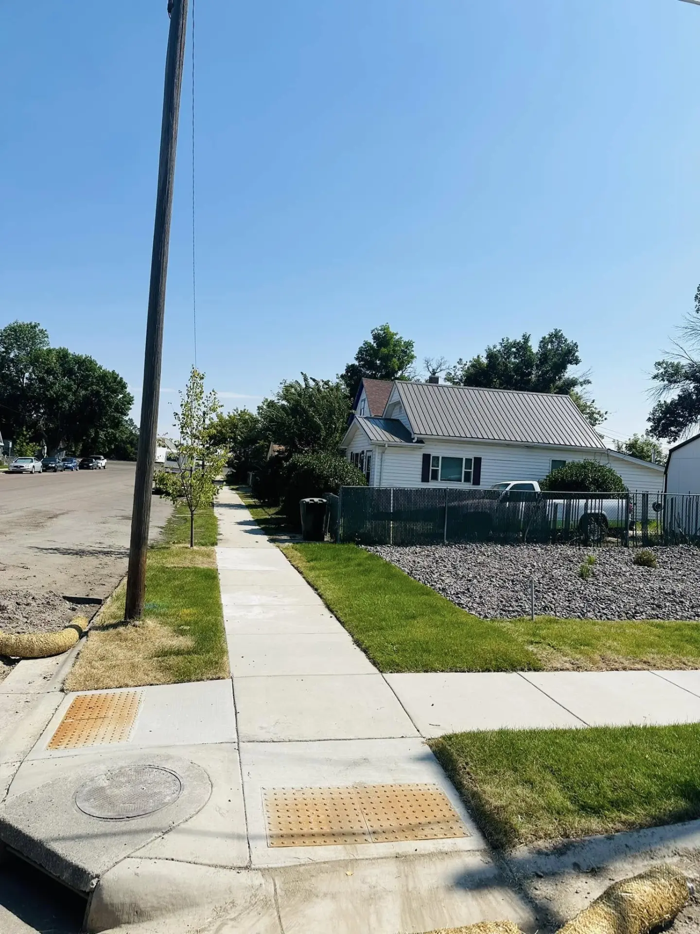 New concrete sidewalk running past a home