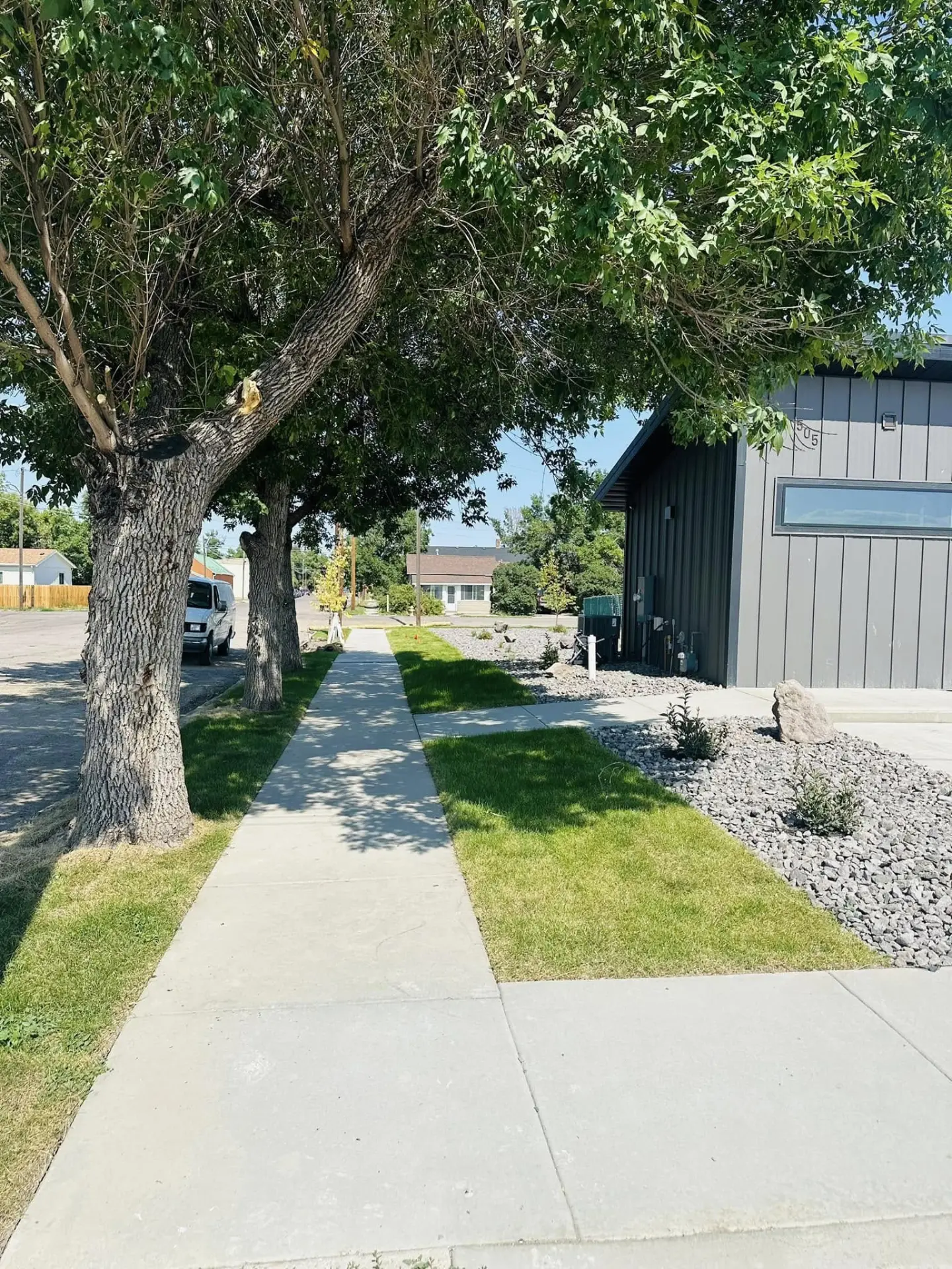 Finished concrete walkway running past a completed property